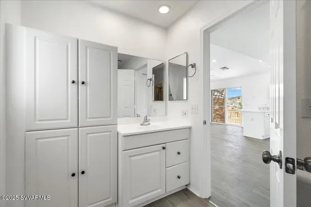 a bathroom with a granite countertop sink mirror and double