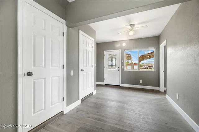 an empty room with entrance and windows