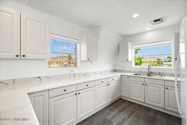 a kitchen with sink stove and cabinets