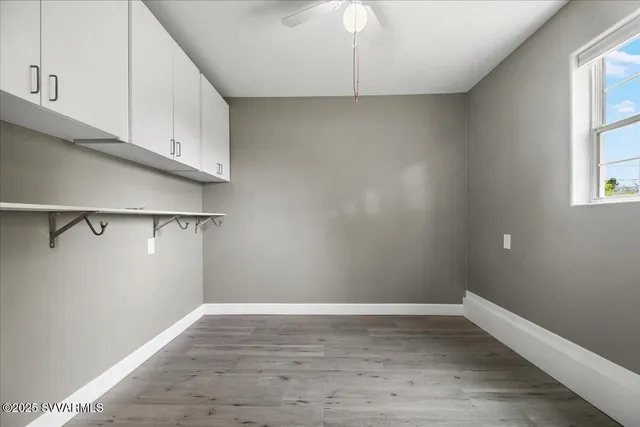 a view of a room with wooden floor and cabinet