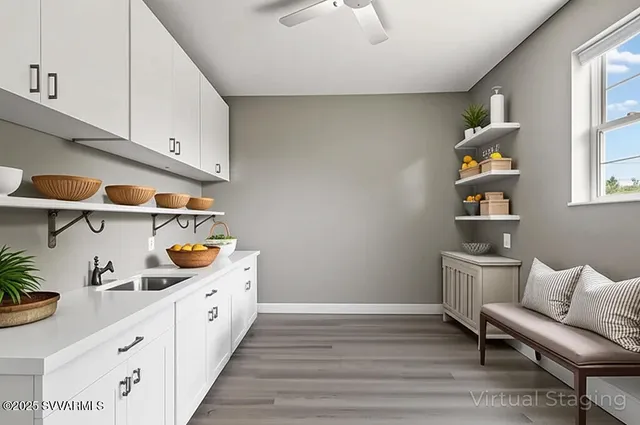 a kitchen with stainless steel appliances granite countertop a lot of cabinets and wooden floor