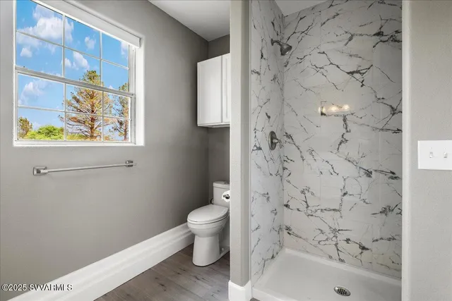 a bathroom with a toilet and a shower curtain