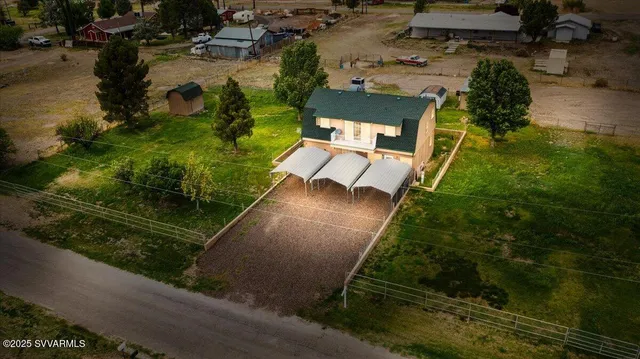 an aerial view of a house with a yard