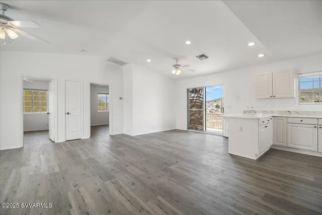 a view of a kitchen with wooden floor and a sink