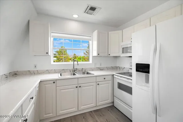 a kitchen with a sink stove and cabinets