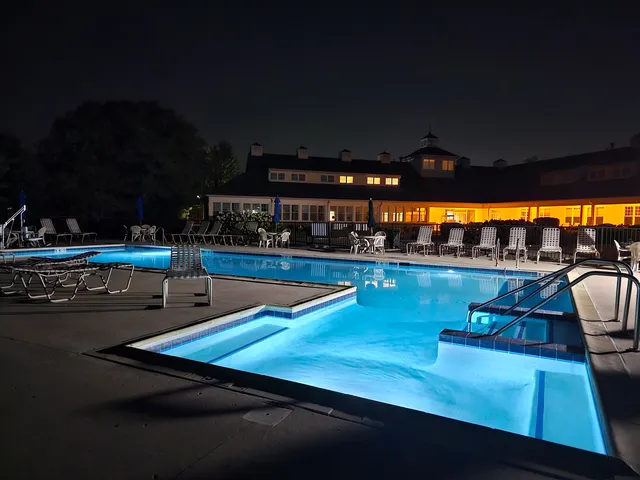 a view of a swimming pool with an outdoor seating