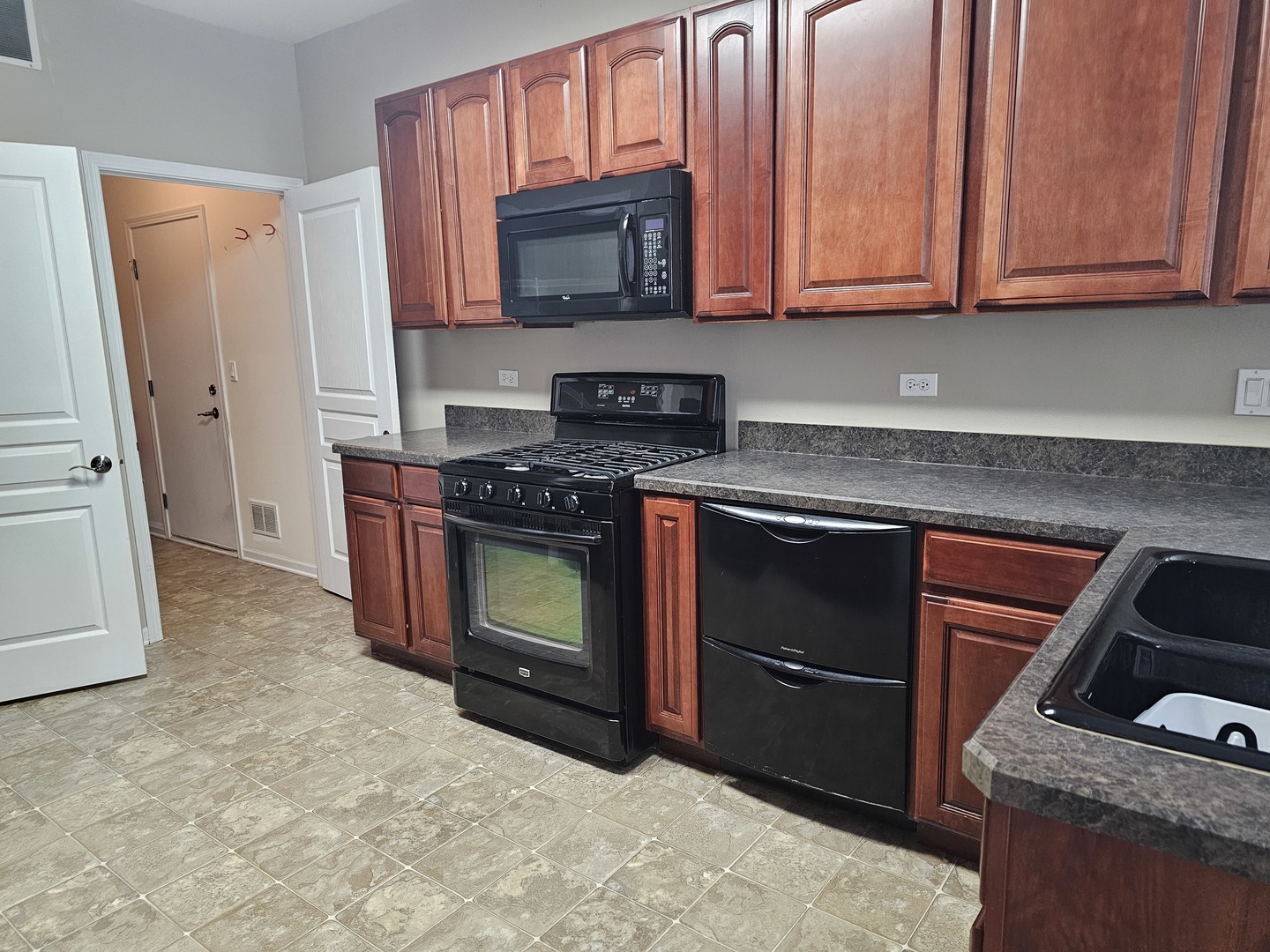 16613 Buckner Pond Way Crest Hill, IL 60403 - Photo 5 of 20 a kitchen with granite countertop a stove top oven microwave and refrigerator