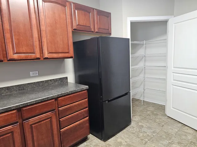a kitchen with stainless steel appliances granite countertop a refrigerator and a cabinets