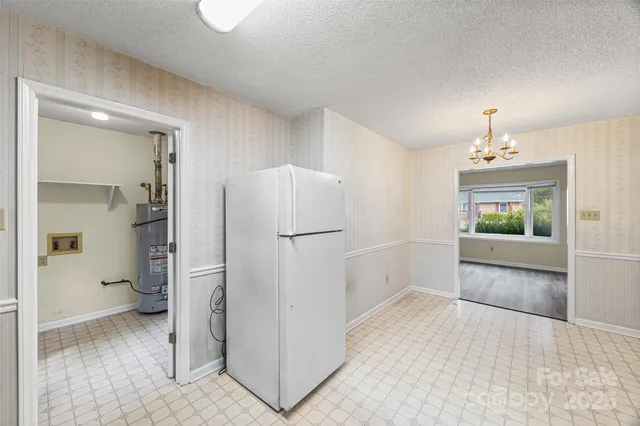 a view of kitchen with refrigerator and window