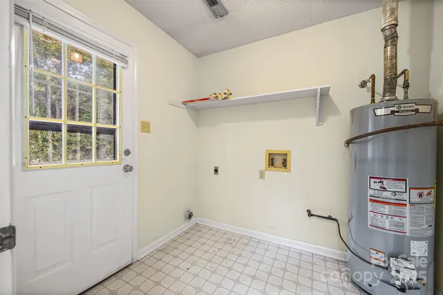 a view of storage and utility room with a window