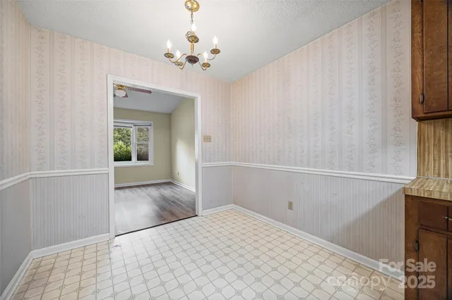 a view of a livingroom with wooden floor and staircase