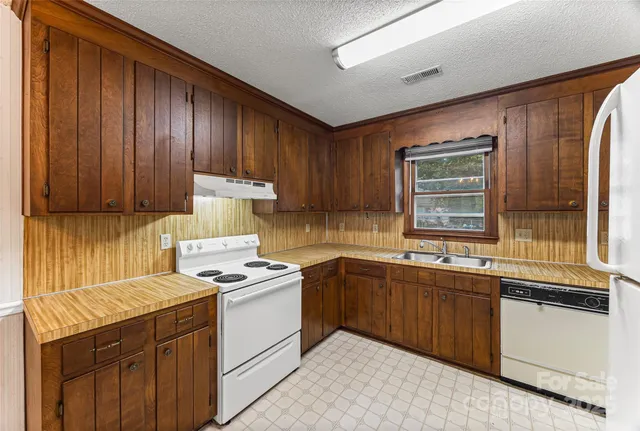 a kitchen with a sink stove and cabinets