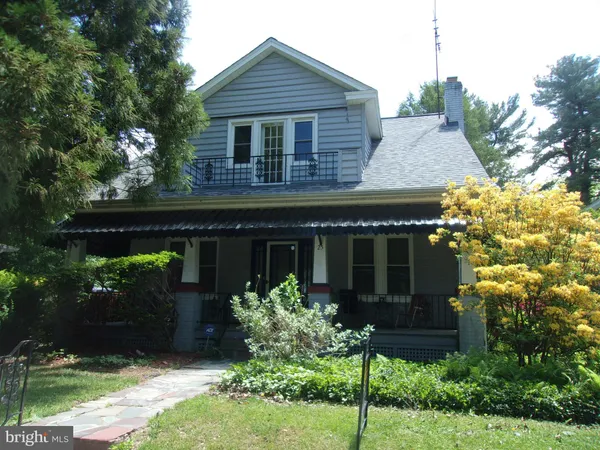 a front view of house with a garden