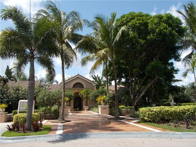 a view of a street with palm trees