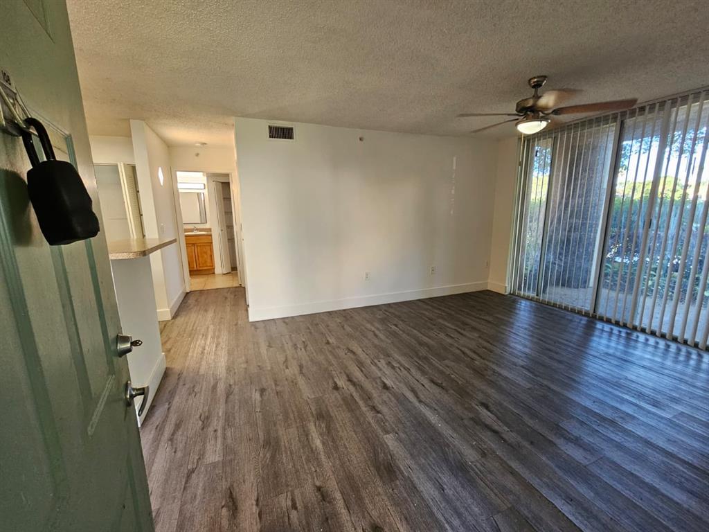 12118 St Andrews Place, Unit 108 Miramar, FL 33025 - Photo 5 of 15 wooden floor in an empty room