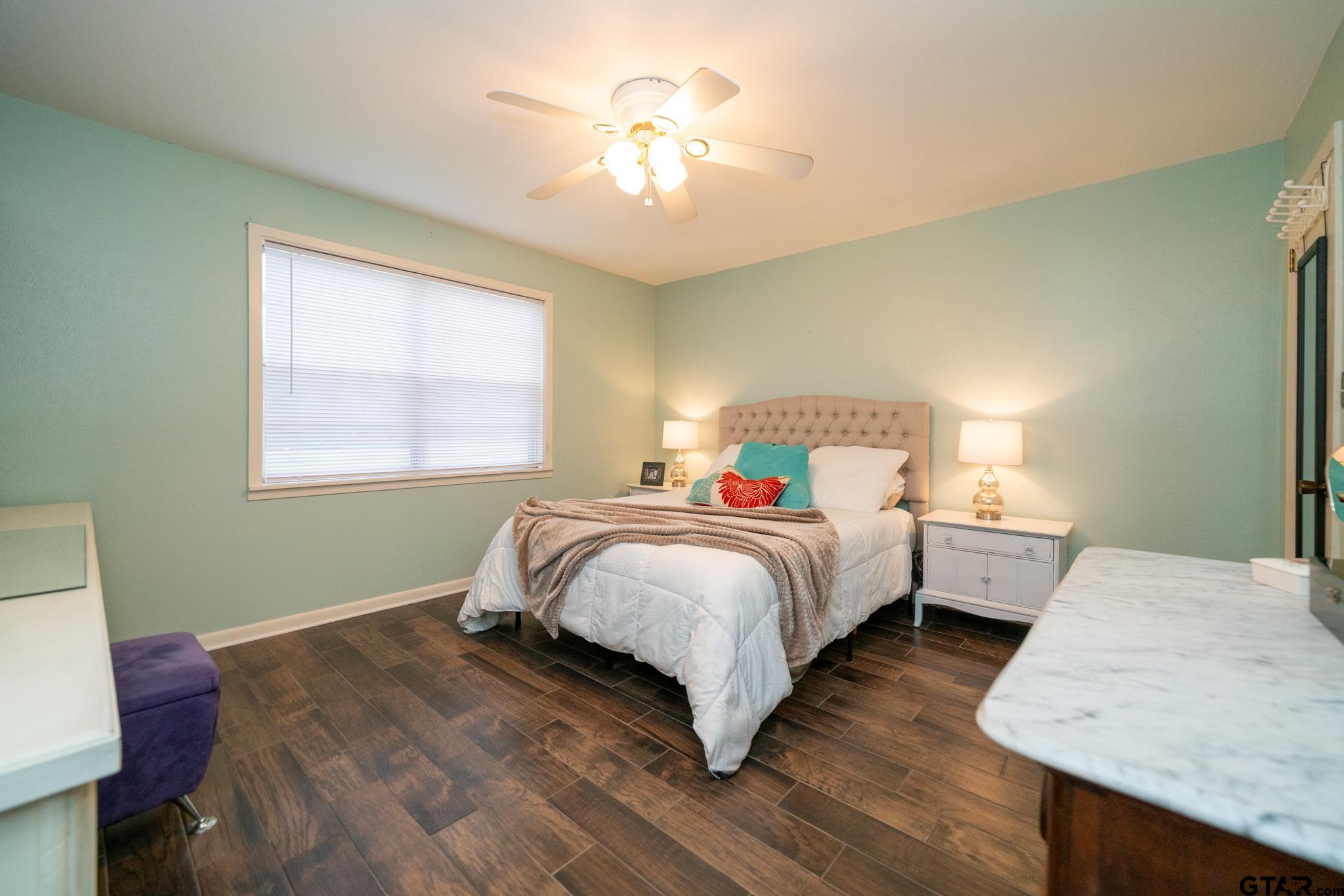 102 Randal Lane Pittsburg, TX 75686 - Photo 11 of 42 a bedroom with a bed and a chandelier