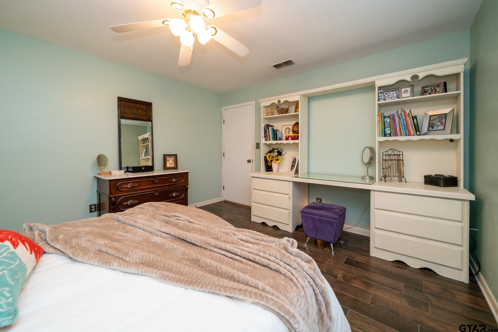 102 Randal Lane Pittsburg, TX 75686 - Photo 12 of 42 a bedroom with a bed and a book shelf