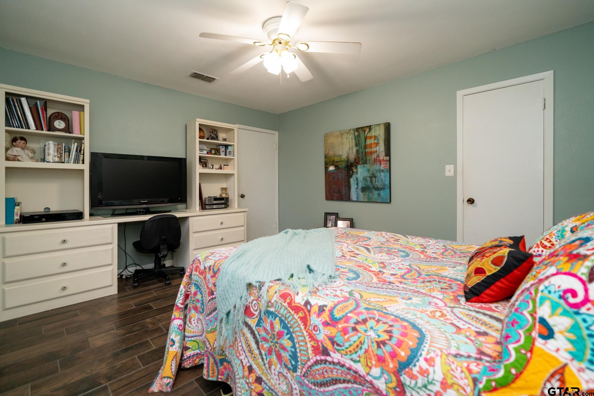 102 Randal Lane Pittsburg, TX 75686 - Photo 14 of 42 a bedroom with a bed and a flat screen tv