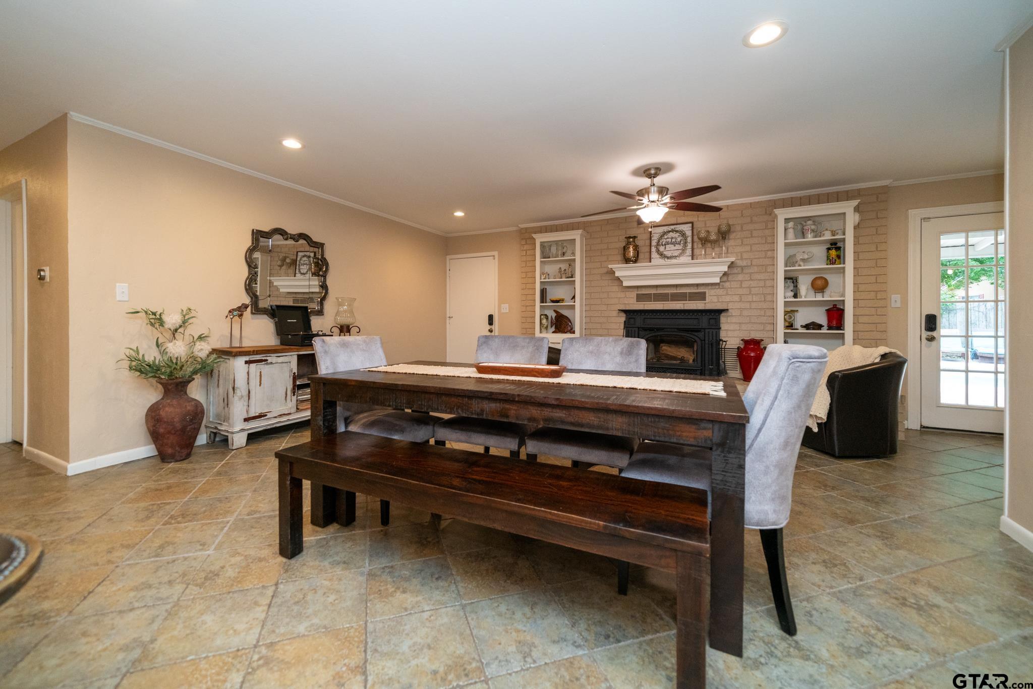 102 Randal Lane Pittsburg, TX 75686 - Photo 26 of 42 a living room with furniture a fireplace and a chandelier