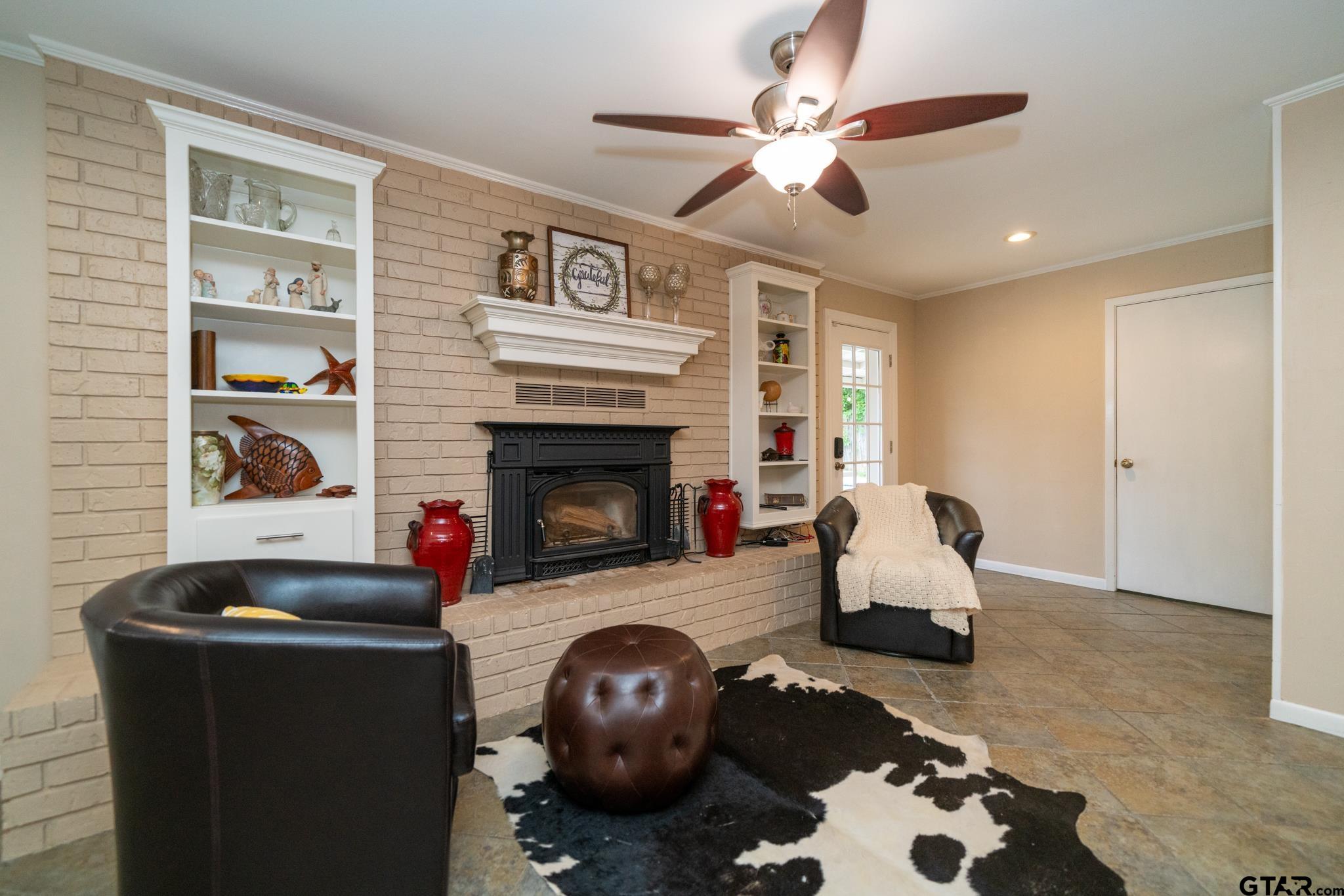 102 Randal Lane Pittsburg, TX 75686 - Photo 28 of 42 a living room with furniture and a fireplace