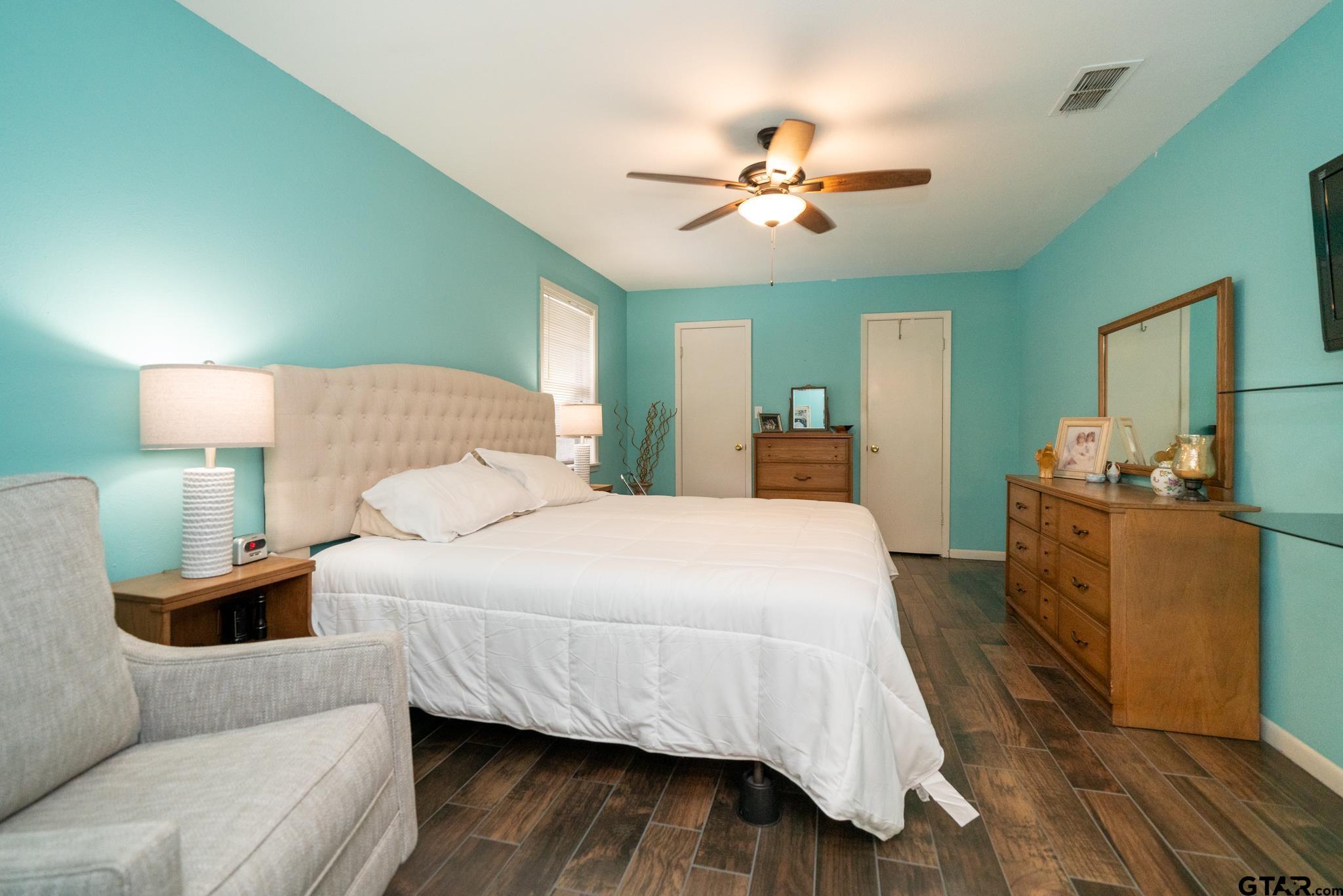 102 Randal Lane Pittsburg, TX 75686 - Photo 31 of 42 a bedroom with a bed and a chandelier