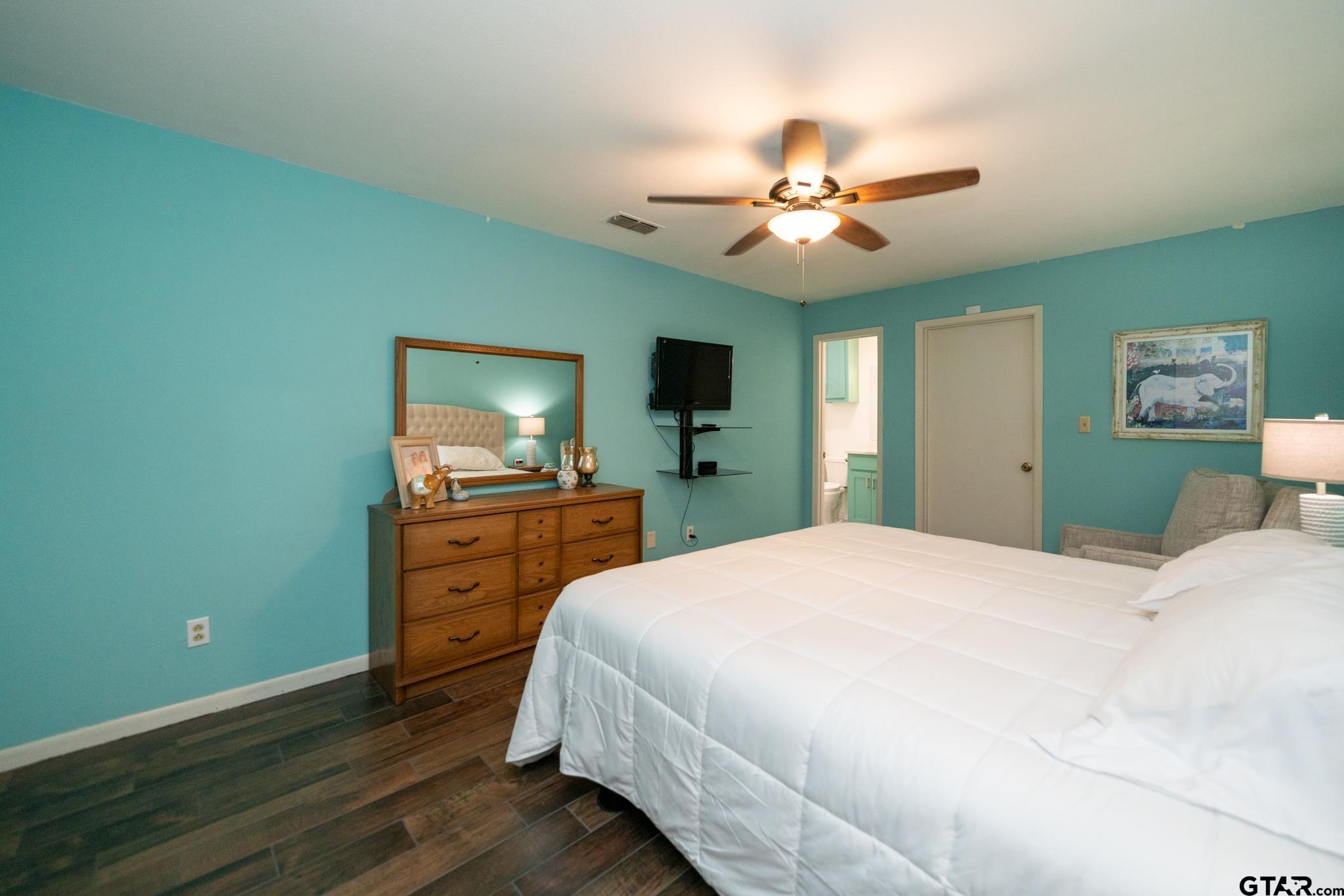 102 Randal Lane Pittsburg, TX 75686 - Photo 32 of 42 a bedroom with a bed and a flat screen tv