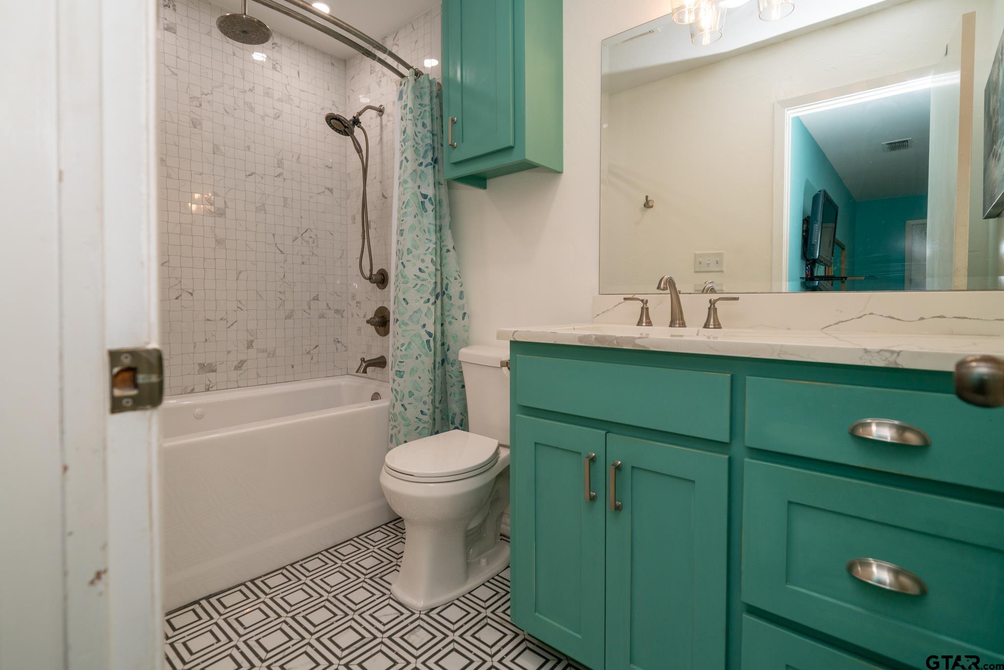 102 Randal Lane Pittsburg, TX 75686 - Photo 33 of 42 a bathroom with a sink a toilet and shower