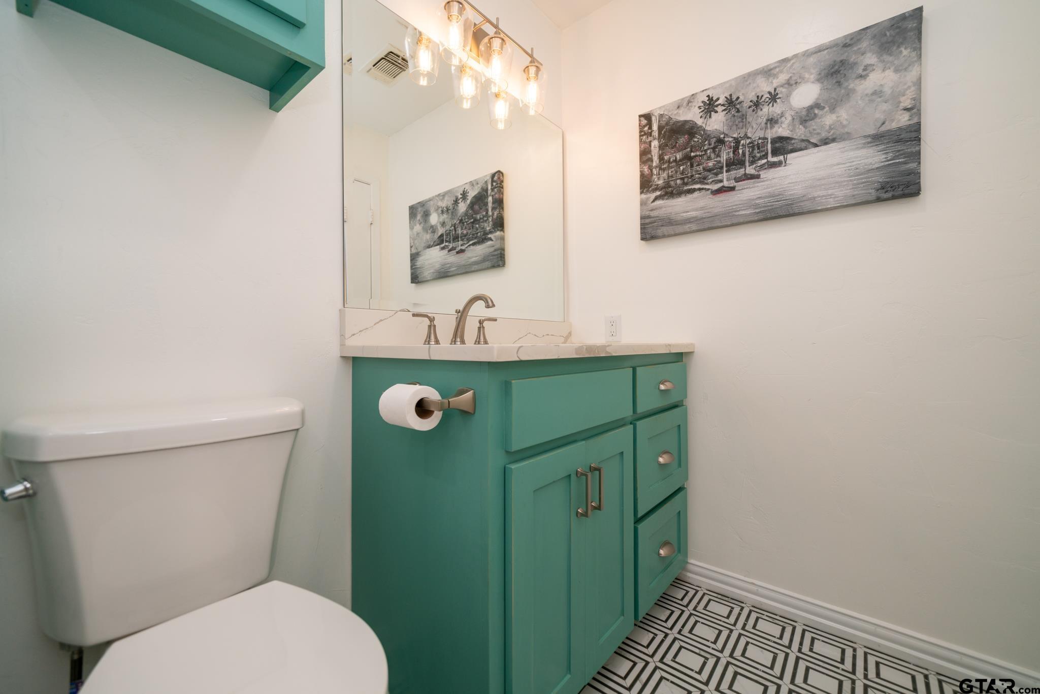 102 Randal Lane Pittsburg, TX 75686 - Photo 34 of 42 a bathroom with a toilet sink and mirror