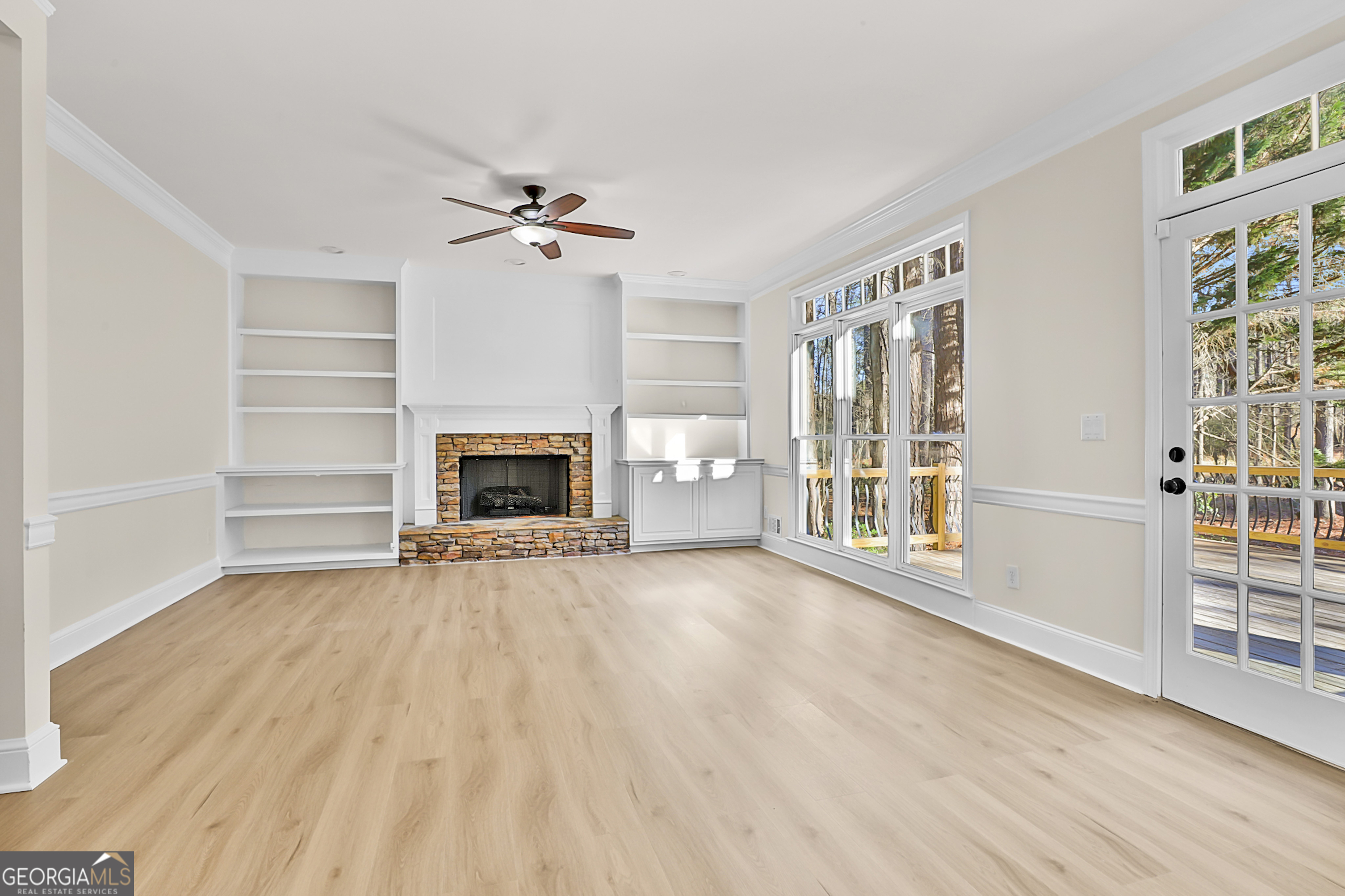 160 Streamview Court Fayetteville, GA 30215 - Photo 18 of 55 an empty room with wooden floor fireplace and windows