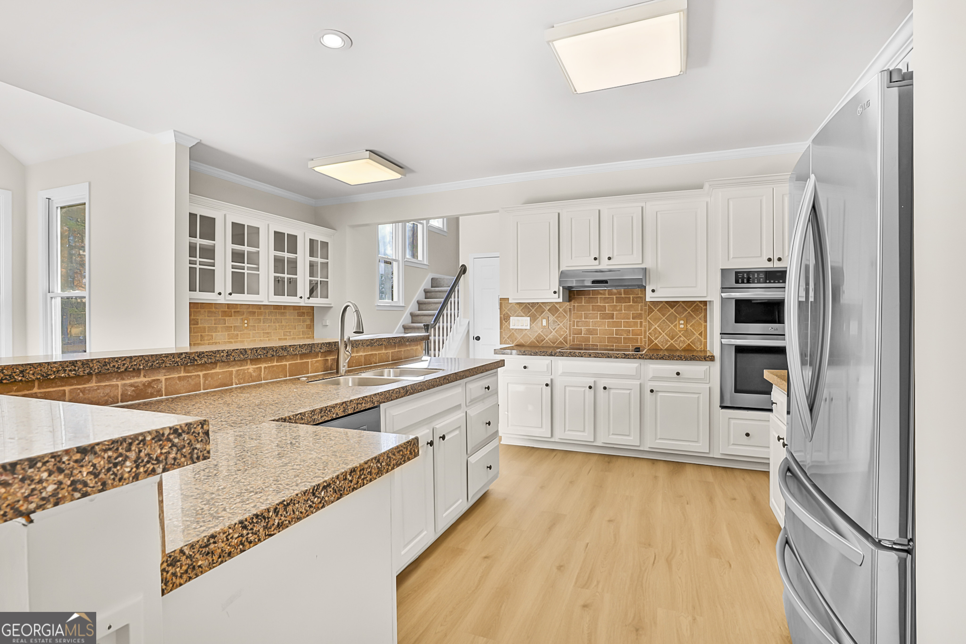 160 Streamview Court Fayetteville, GA 30215 - Photo 26 of 55 a kitchen with stainless steel appliances granite countertop a refrigerator and cabinets