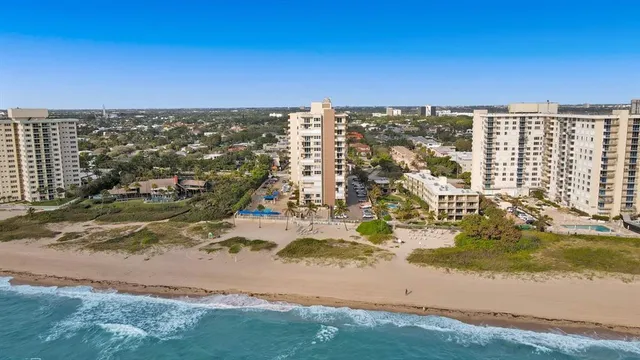 an aerial view of residential building and ocean view
