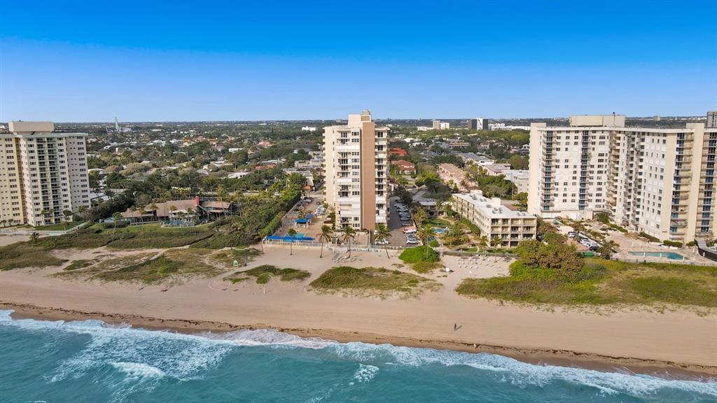an aerial view of residential building and ocean view