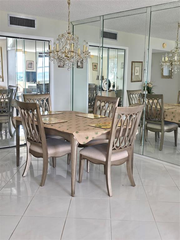 2000 South Ocean Boulevard, Unit 8F Lauderdale-by-the-Sea, FL 33062 - Photo 15 of 35 a view of a dining room with furniture and chandelier