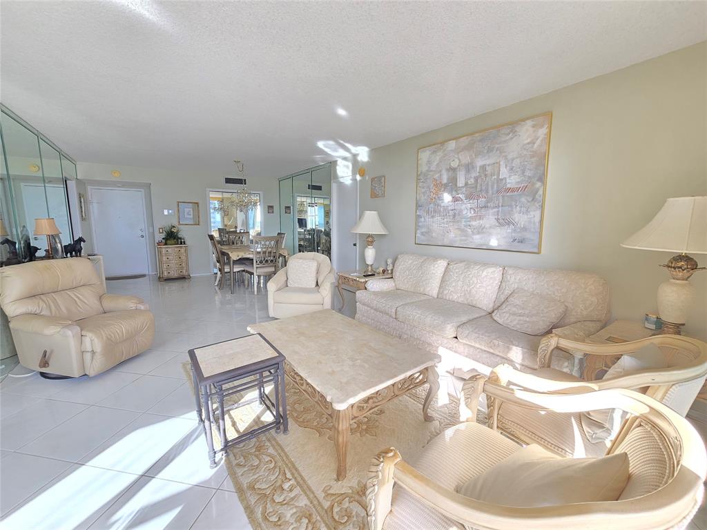 2000 South Ocean Boulevard, Unit 8F Lauderdale-by-the-Sea, FL 33062 - Photo 19 of 35 a living room with furniture and a table