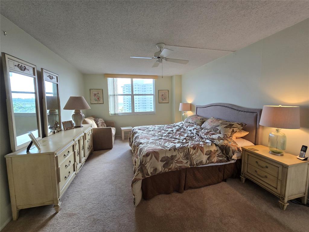2000 South Ocean Boulevard, Unit 8F Lauderdale-by-the-Sea, FL 33062 - Photo 21 of 35 a bedroom with a bed and a couch