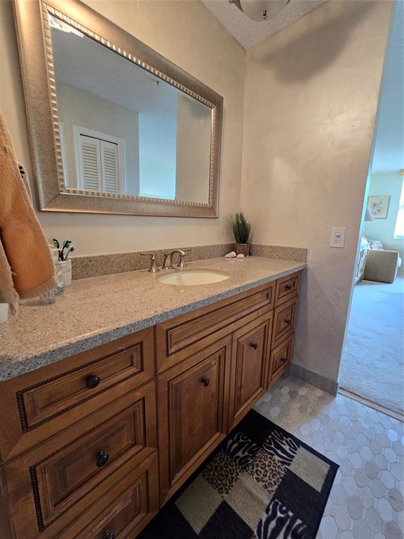 2000 South Ocean Boulevard, Unit 8F Lauderdale-by-the-Sea, FL 33062 - Photo 22 of 35 a spacious bathroom with a granite countertop sink and a mirror