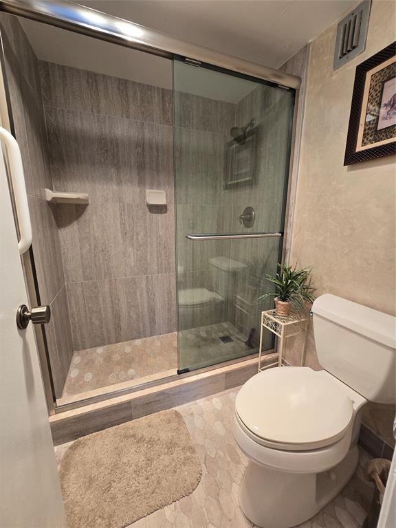 2000 South Ocean Boulevard, Unit 8F Lauderdale-by-the-Sea, FL 33062 - Photo 23 of 35 a bathroom with a toilet and a shower