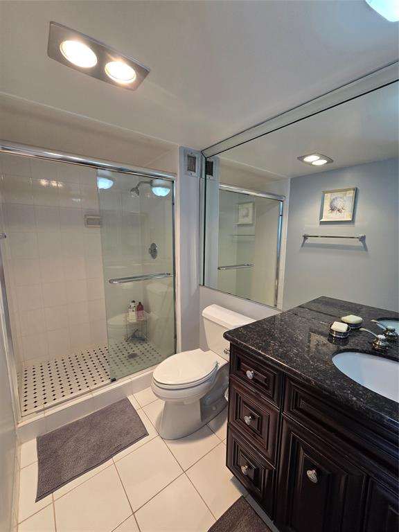 2000 South Ocean Boulevard, Unit 8F Lauderdale-by-the-Sea, FL 33062 - Photo 25 of 35 a bathroom with a granite countertop sink toilet mirror and shower