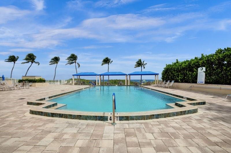 2000 South Ocean Boulevard, Unit 8F Lauderdale-by-the-Sea, FL 33062 - Photo 3 of 35 a view of a swimming pool with a yard