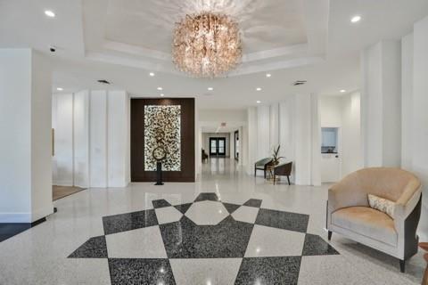 2000 South Ocean Boulevard, Unit 8F Lauderdale-by-the-Sea, FL 33062 - Photo 10 of 35 a living room with furniture and a chandelier