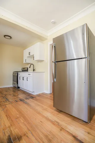 a kitchen with granite countertop a refrigerator and a sink