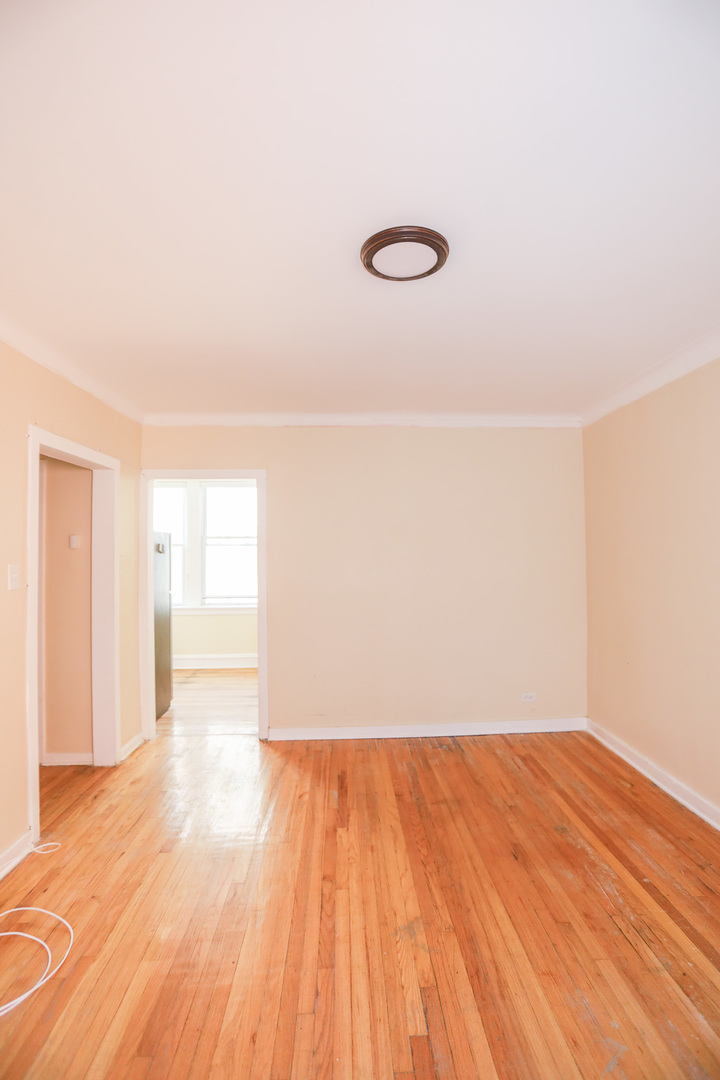 4019 West School Street, Unit 1W Chicago, IL 60641 - Photo 7 of 8 a view of empty room with wooden floor