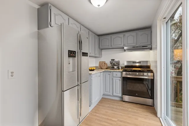 a kitchen with stainless steel appliances a refrigerator sink and cabinets