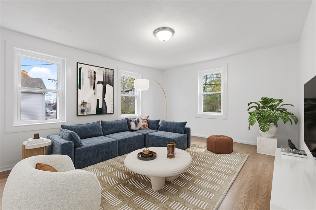 12 Thorndike Street Salem, MA 01970 - Photo 4 of 14 a living room with furniture and a potted plant
