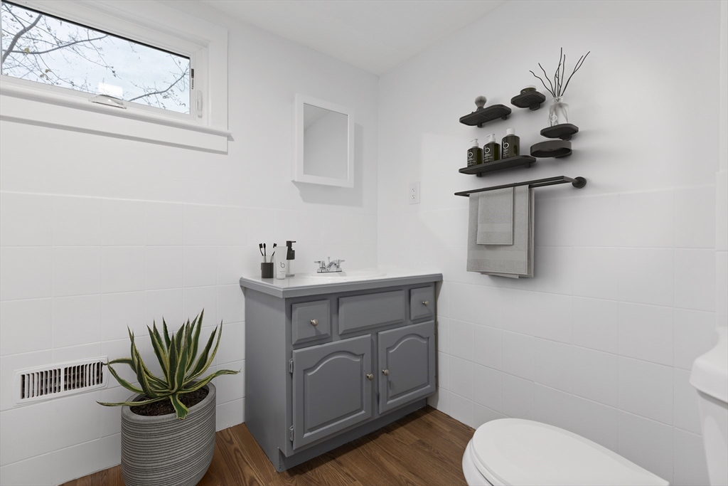 12 Thorndike Street Salem, MA 01970 - Photo 8 of 14 a bathroom with a toilet sink and mirror