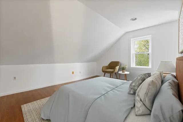 a bed sitting in a bedroom next to a window