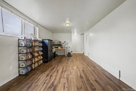 a view of a room with wooden floor and shoes