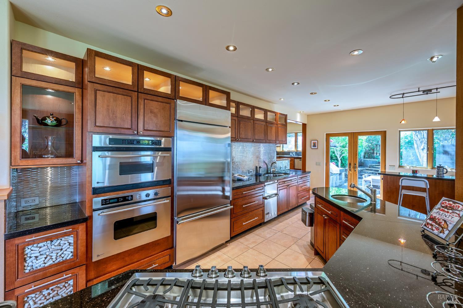 35148 Crows Nest Drive The Sea Ranch, CA 95497 - Photo 27 of 94 a kitchen with stainless steel appliances kitchen island granite countertop a stove and white cabinets