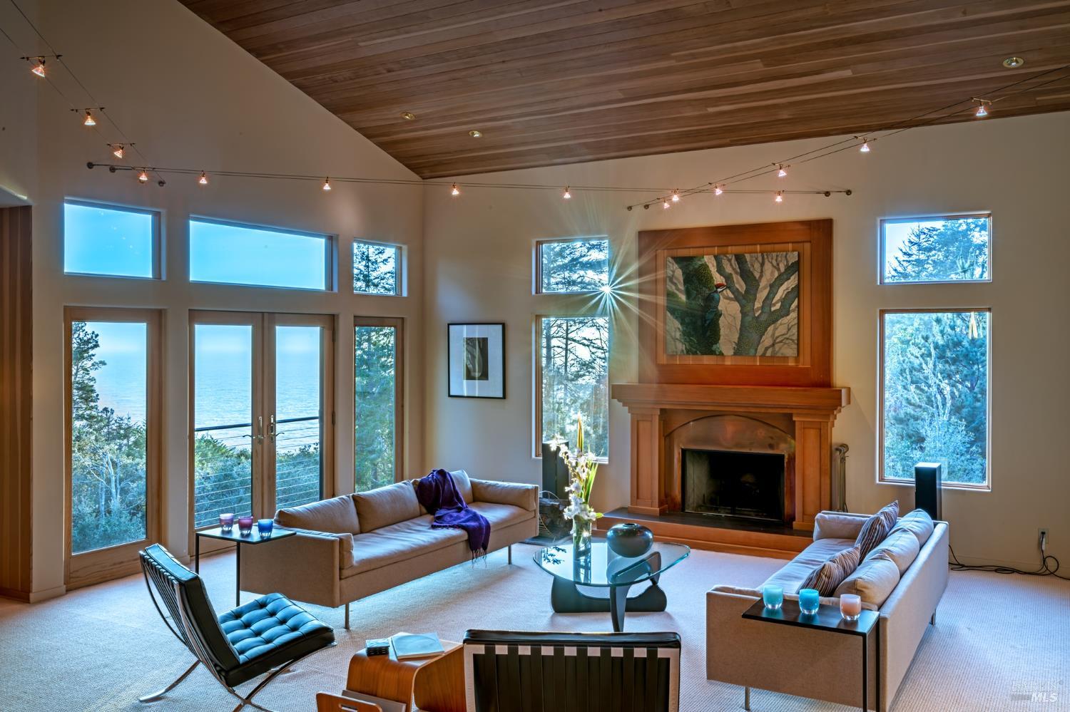 35148 Crows Nest Drive The Sea Ranch, CA 95497 - Photo 39 of 94 a living room with furniture a floor to ceiling window and a fireplace