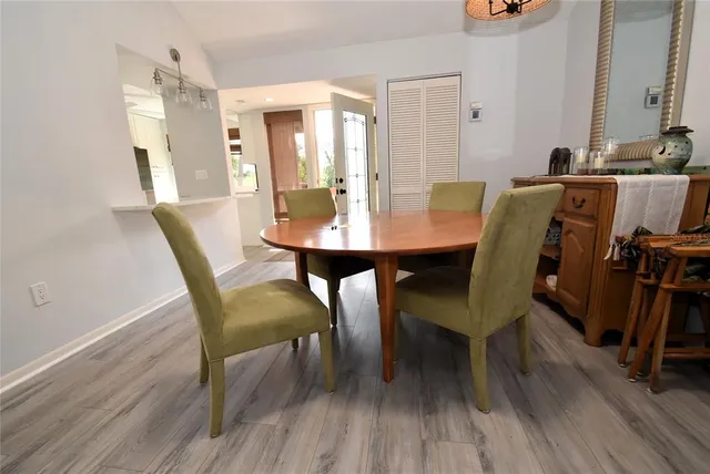 a view of a a dining room with furniture and wooden floor